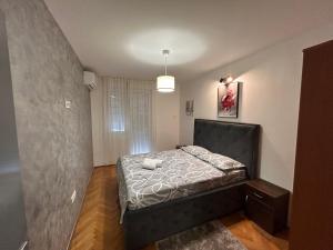 a small bedroom with a bed in a room at Apartments Ciki in Podgorica