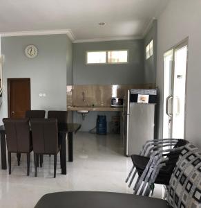 a kitchen and dining room with a table and a refrigerator at Bromo Camp House in Bromo
