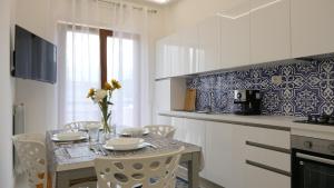 a kitchen with a table and chairs in a kitchen at Maison Lucia in Castellammare di Stabia