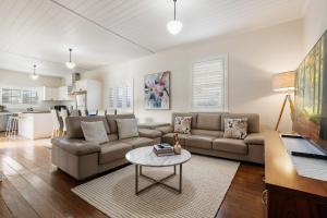 a living room with a couch and a table at Sampson Cottage - Historic Charm in Orange