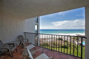 a balcony with chairs and a view of the beach at Beachside II by Panhandle Getaways in Destin