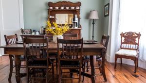 a dining room table with chairs and a mirror at Russelltown Inn in Bonavista