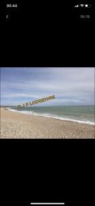 a picture of a beach with the words novoboarding at Lodge for Hire in Pagham