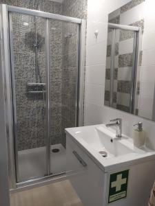 a bathroom with a shower and a sink at Casa da Formosa in Silveira +4 photos