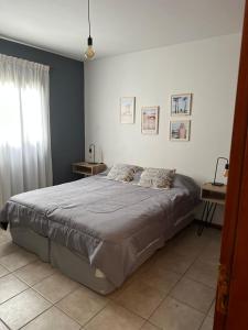 a bedroom with a large bed in a room at - Cambacuá VM - in Villa María
