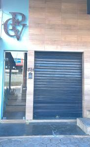 a large blue garage door on the side of a building at Vitor Moreira pousada campo verde ltda in São João del Rei