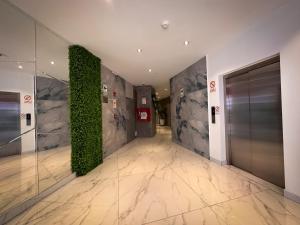 a hallway in a building with a green wall at MIRAFLORES CITY HOTEL in Lima