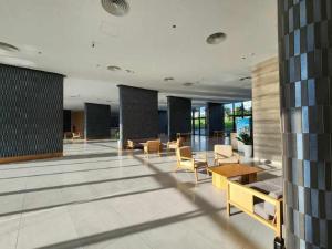 a lobby with chairs and tables in a building at Cam Ranh Nha Trang Seaview Resort in Cam Ranh