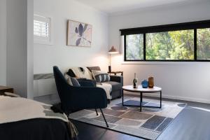 a bedroom with a bed and a couch and a table at Ablac Studio in Glenlyon