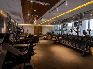 a gym with several rows of treadmills and machines at Galeria Plaza Monterrey in Monterrey
