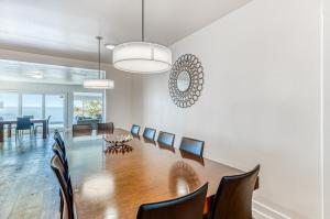 a dining room with a long table and chairs at Oceanside Skies in Oceanside