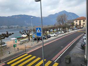 una calle con coches aparcados al lado de una carretera en Meraviglioso appartamento fronte lago, en Bissone