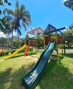 a playground with a slide in a park at Exclusiva Suíte Granja Brasil in Petrópolis