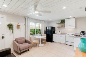 a kitchen with a table and a chair and a table at Beachside Retreat W Heated Pool in St Pete Beach