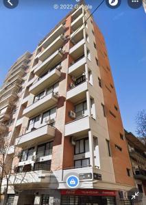 a tall building with a sign in front of it at Apartamento amoblado tipo loft in Buenos Aires