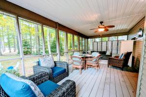 a screened in porch with furniture and a table at Brandywine Home in the Pines in Ocean Pines