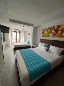 a bedroom with a large bed and a couch at HOTEL CASA BRESSE in Cali +70 photos