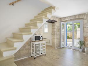 a staircase in a living room with a microwave at Holiday Home in Medulin with Bubble Bath in Medulin