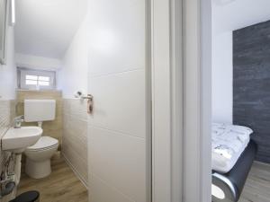 a small bathroom with a toilet and a sink at Holiday Home in Medulin with Bubble Bath in Medulin +25 photos
