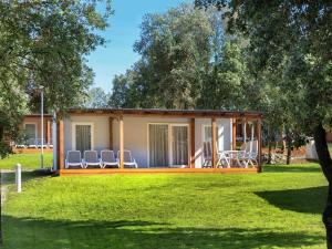 a house with chairs in a yard at Comfortable chalet 4 5 km from Rovinj in Rovinj