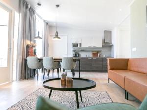 a living room with a couch and a table at Bungalow in Netherlands with Garden Terrace in 's-Gravenzande