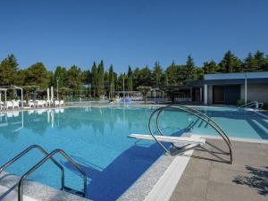 a large swimming pool with a slide in it at Modern chalet with 2 bathrooms and a veranda in Vrsar