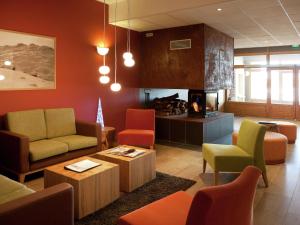 a waiting room with colorful furniture and a fireplace at Modern apartment near the ski lift in an authentic village in Sainte-Foy-Tarentaise
