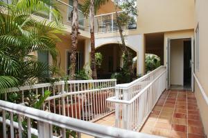 a balcony of a house with palm trees at Coral Princess Hotel in San Juan