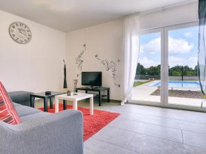 a living room with a couch and a clock on the wall at Villa in Barban near Beach & Pool in Rebići