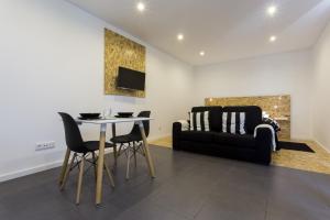 a living room with a table and a couch at Quinta das Rosas Villas in Ribeira Grande