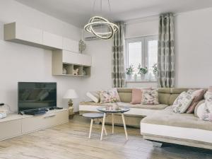 a living room with a couch and a tv at Modern Villa with Pool and Parasol in Pula in Pula