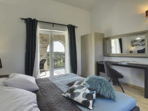a bedroom with a bed and a desk and a mirror at Villa in Rovinj with Pool and Sauna in Rovinjsko Selo +32 photos