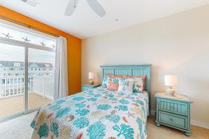 a bedroom with a bed and a large window at Seaside Village - SunnyG in Ocean City