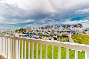 a balcony with a view of a marina at Seaside Village - SunnyG in Ocean City