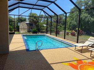 a swimming pool in a house with a glass roof at Short term vacation rental luxury B&B CTH in Englewood