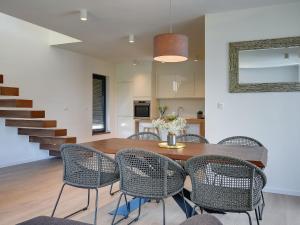 a dining room with a wooden table and chairs at Modern villa swimming pool , outdoor kitchen and fenced garden in Pula