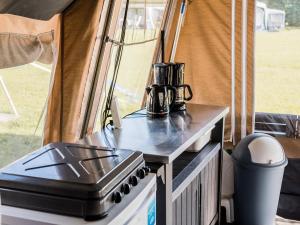 a stove top oven sitting on a table in a tent at Tent Lodge in Nommern near Forest in Nommern