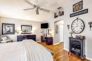 a bedroom with a large bed and a clock on the wall at The Gardenia House in The Villages