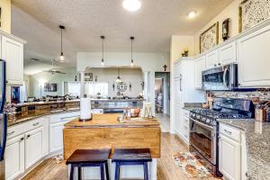 a kitchen with white cabinets and a table and chairs at The Gardenia House in The Villages