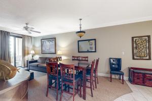 a living room with a dining room table and chairs at Emerald Grande W621 in Destin