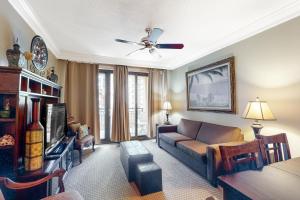 a living room with a couch and a tv at Emerald Grande W621 in Destin