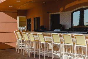 a row of chairs lined up next to a bar at Emerald Grande W621 in Destin +21 photos