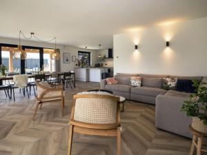 - un salon avec un canapé et une table dans l'établissement Beautiful villa on the water, on a holiday park in Friesland, à Sint Nicolaasga