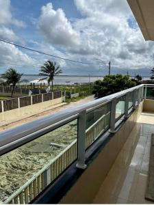 a balcony with a view of the beach at Pousada Mar & Sol in Tutóia