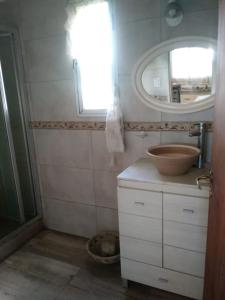 a bathroom with a sink and a mirror at El Resueyo de Saladillo in Saladillo