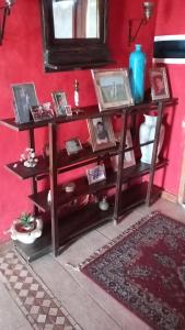 a shelf in a room with pictures on it at El Resueyo de Saladillo in Saladillo