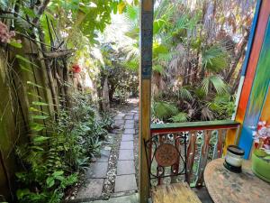 a balcony with a gate and a walkway with plants at Miami Bungalow Oasis near Everglades & The Keys in Cutler Bay
