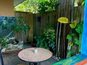 a table in front of a fence with a tree at Miami Bungalow Oasis near Everglades & The Keys in Cutler Bay