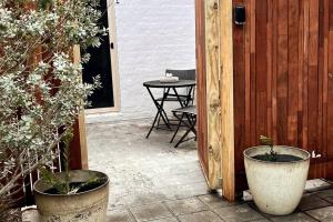 a patio with two potted plants and a table at Marengo Beach Studio 4- Pet Friendly in Marengo