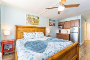 a bedroom with a large bed with a wooden headboard at MCM Retro Beachfront Studio Great View, King Bed Remodeled in Daytona Beach